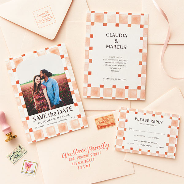 A modern wedding invitation suite in coral colors.