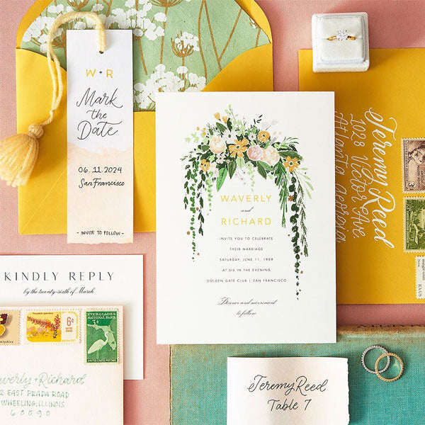 Colorful wedding invitation suite with a floral theme.