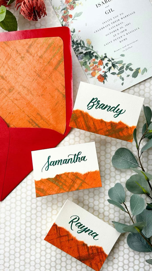 Place cards crafted with vibrant fine paper.