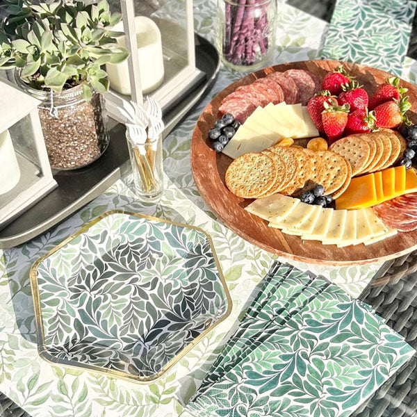Garden party plates and napkins displayed with charcuterie.