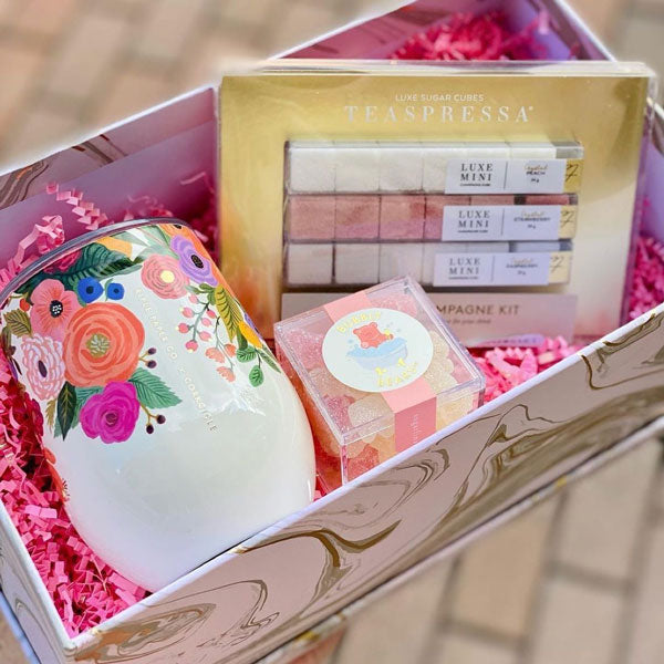 Bridal party gift box with candy and drinkware inside.
