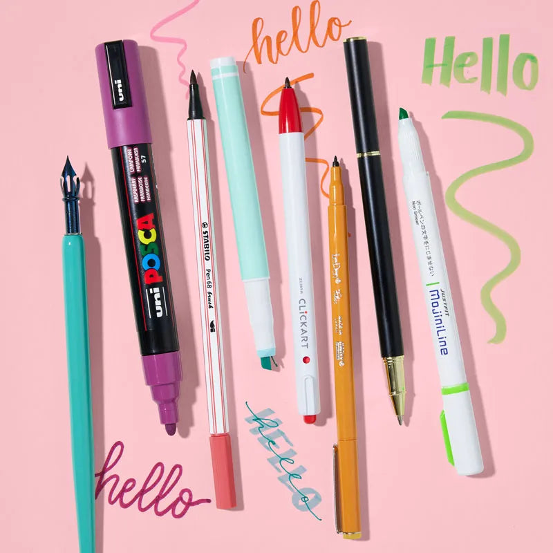 Variety of pens and markers with scribbles displaying their colors and tip sizes.