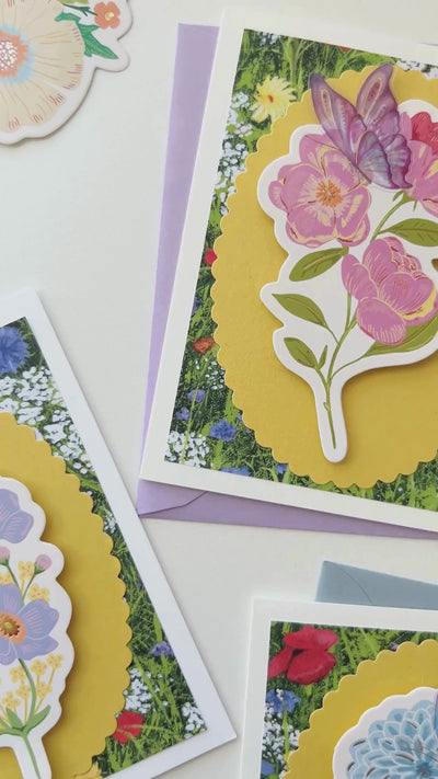 Video detailing how to create a floral handmade card using gift tags and stickers.