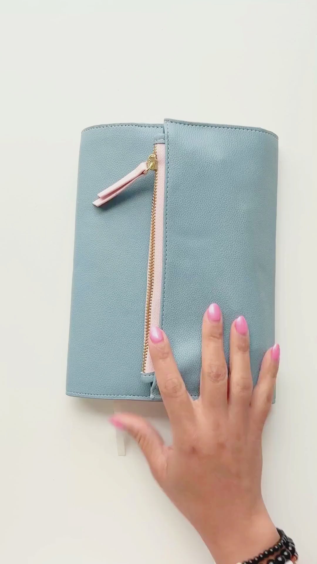 Video displaying how to create a travel journal spread with photos and embellishments.
