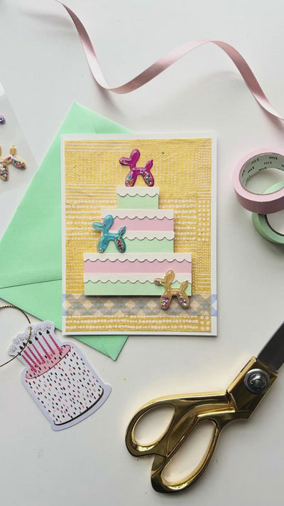 Video displaying how to create a balloon animal handmade birthday card with stickers and washi tape.