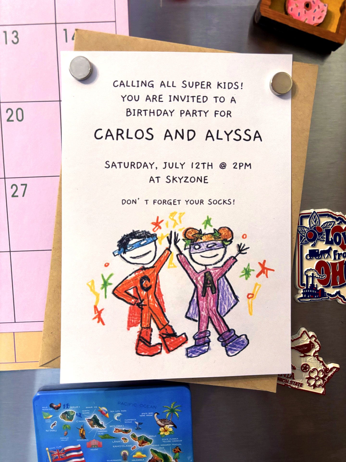 Party invitation featuring custom artwork of superheroes drawn by a child.