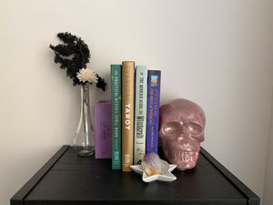 Display of Tarot books, a vase and a skull.