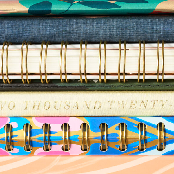 Close up of different planner bindings including spiral and perfect bound.
