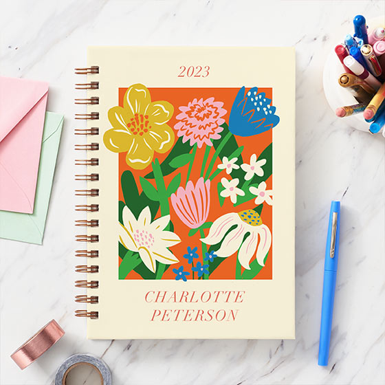 Custom planner with vibrant illustrated floral design on the cover.